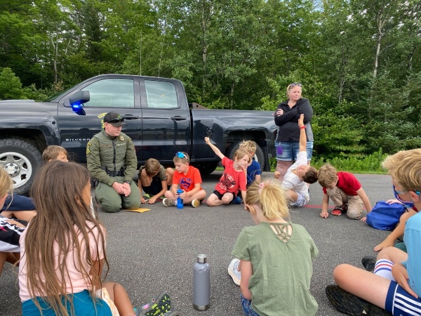 Local game warden visits Collaborative Camp youth to talk about conservation.
