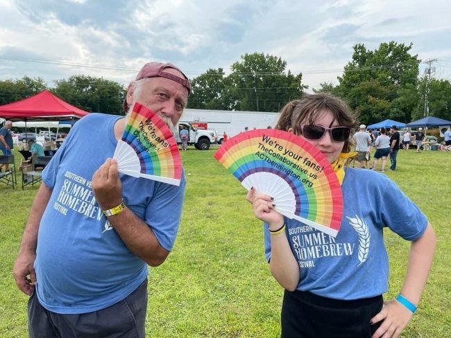Bennington Brew Fest Fans Two community members at the Brew Fest event holding rainbow fans